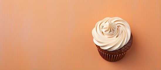 Sugary morning treat Chocolate cupcake topped with vanilla frosting isolated pastel background Copy space - obrazy, fototapety, plakaty