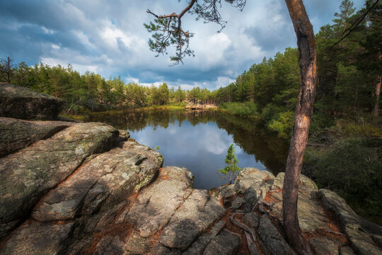 small lake among rocks and forest on a sunny autumn day. The famous Devil Lake in Karkaralinsk in Kazakhstan