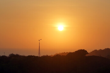 communication tower during sunrise or sunset. radio frequency transmission tower                   