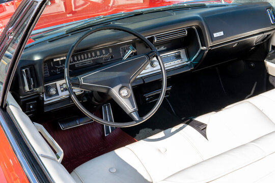 Snohomish, WA, USA - 25 September 2022. Interior of Red Cadillac Deville 1967. Retro car, retro torpedo car, vintage steering wheel, speedometer