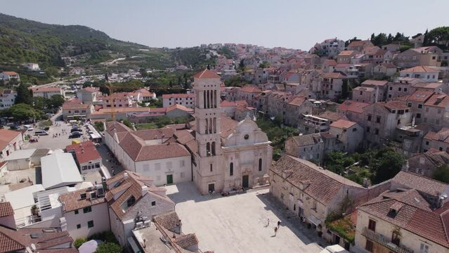 Aerial: Croatia Hvar's Roman Catholic diocese church, showcasing historic charm and scenic surroundings