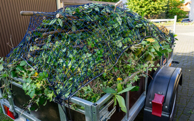Trailer with garden waste in autumn