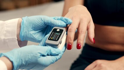 Pulse oximeter on a white background. Infrared isometric thermometer to check body temperature for virus symptoms. Measures oxygen saturation, heart rate and oxygen levels.