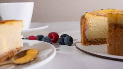 close-up of cheesecake with cream filling, decorated with fresh berries, blueberries and raspberries, festive New Year's cake, Christmas