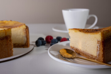 close-up of cheesecake with cream filling, decorated with fresh berries, blueberries and raspberries, festive New Year's cake, Christmas