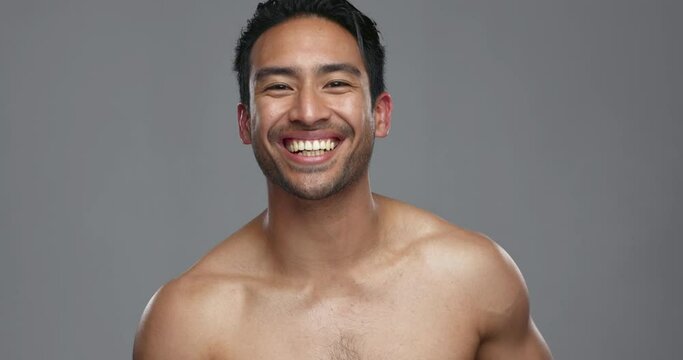 Happy asian man, deodorant and armpit spray for hygiene, grooming or fresh smell against a grey studio background. Portrait of male person smile for cleaning, cosmetics or skincare product on mockup