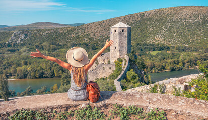 Tour tourism, travel, vacation in Bosnia- Woman enjoying panorami view of old castle in Pocitelj