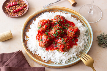 Rice with meatballs in tomato sauce. Italian food.