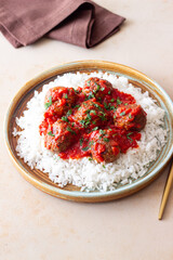 Rice with meatballs in tomato sauce. Italian food.