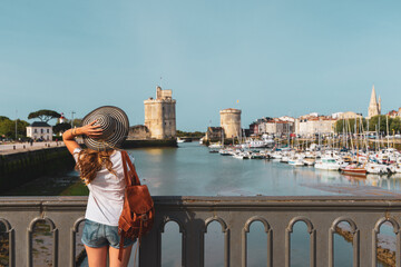 Fototapeta na wymiar Woman tourist enjoying city landscape of La Rochelle- Charente Maritime in France