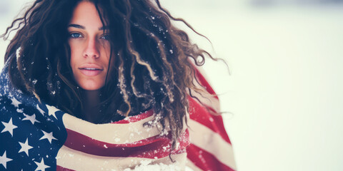 Evocative blonde hippie draped in American flag amidst falling snow, embodying freedom and nature with a muted, chilly color palette. - obrazy, fototapety, plakaty