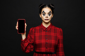 Young woman with Halloween makeup face art mask wearing clown costume red dress hold use blank...