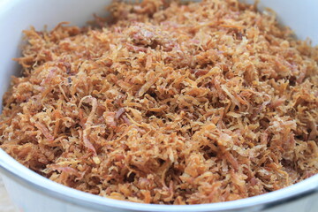 Fried grated sweet potato in a pan on the table