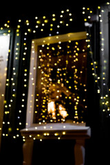 Obraz na płótnie Canvas Defocused blurred shop windows decorated with with christmas lights garland during winter holidays