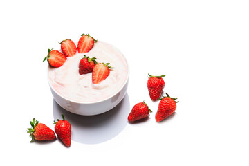 Healthy breakfast of strawberries, fresh Greek yogurt and yogurt cup on white background.