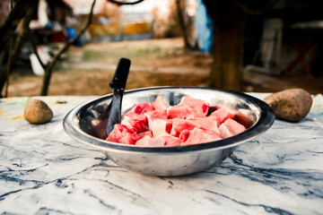 Close up of raw meat pork pieces bbq in metal bowl in the park