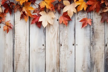 Naklejka na ściany i meble Fall background of autumn leaves, space for text over a white wooden background