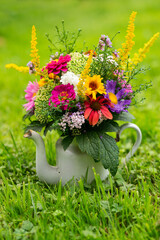 Colorful flower bouquet in a enamel pot - 657499733