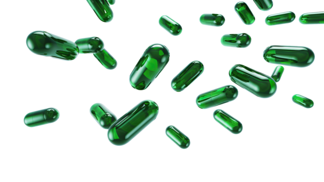 Green medical capsules falling down on the white background