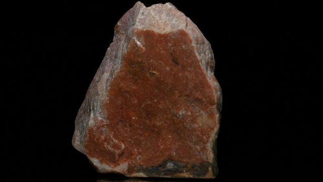 Sunstone (oligoclase feldspar with hematite inclusions) specimen rotating slowly against a black background.