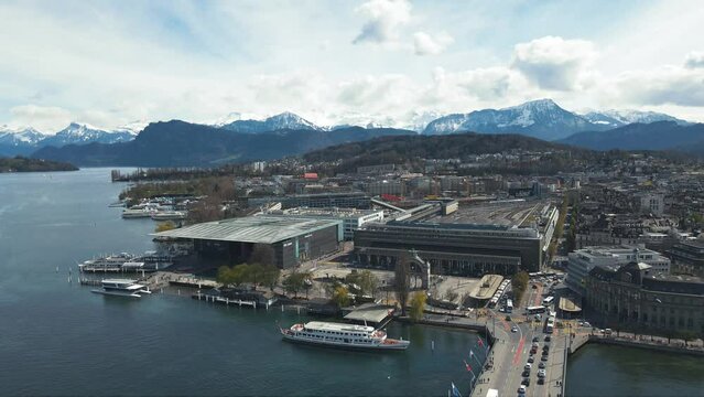 panoramic view of the urban landscape of the city of Lucerne and snow-capped mountain surroundings in Switzerland featuring the Reuss River, Vierwaldst&auml;ttersee, Bahnhof Luzern, and Seebr&uuml;cke 
