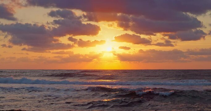 Tropical golden sunrise over ocean waves and beach shore, sea horizon landscape video 