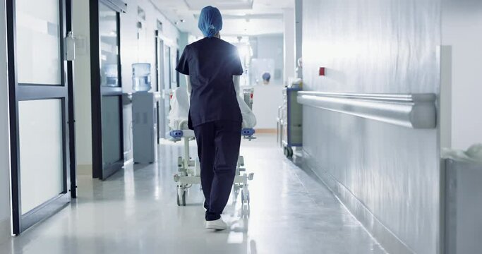 Patient, bed and nurse walking in hospital, hallway or corridor to surgery, operation room or ER healthcare service. Doctor, moving and pushing person in clinic to ICU, bedroom or walk backward