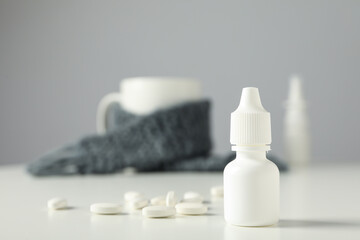 Near a medicine bottle with pills on a light background