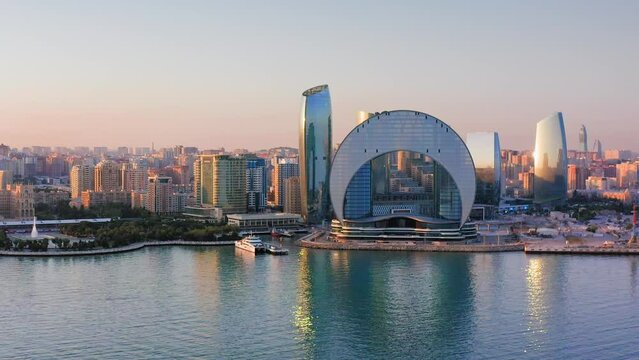 Sunset urban skyline of Baku downtown district and calm Caspian bay, Azerbaijan