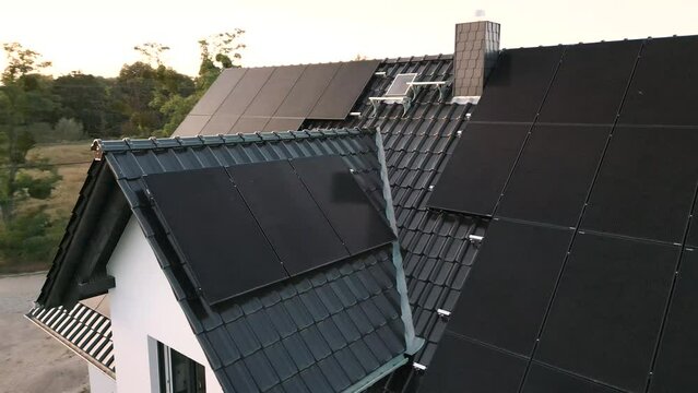 Arc shot of modern solar panels installed on the roof of a single-family house
