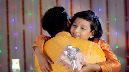 Father and son bonding during Diwali celebration - Son hugging father . A charming young dad and...