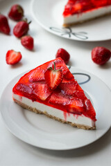 strawberry cheesecake on a plate on a white background