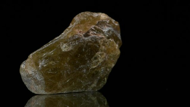 Titanite / Sphene (calcium titanium silicate) specimen rotating slowly against a black background.