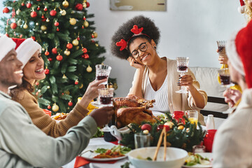 winter holidays and people concept, cheerful multiethnic family and friends celebrating Christmas