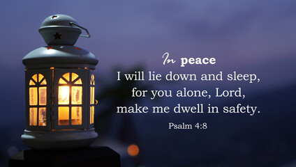 Bible verse quote - In peace I will lie down and sleep, for you alone, LORD, make me dwell in safety. Psalms 4:8. With lantern light shine in the dark night. Christianity concept.
