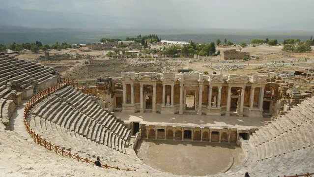 Panorama from the Top of the Ancient Amphitheater, Columns, and Stone Statues Below.