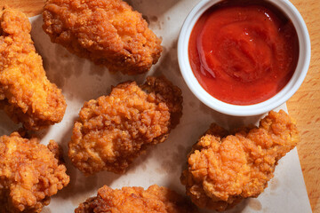 Delicious chicken wings in crispy breading with ketchup. - 657559775