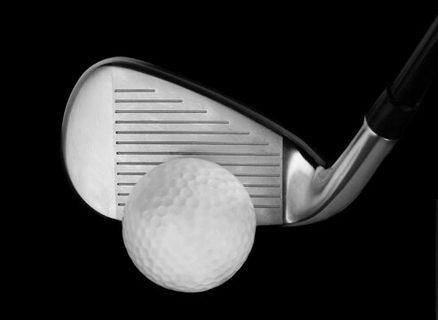 Closeup of a Iron Golf Club with Ball on a Black Background, full screen Studio Shot