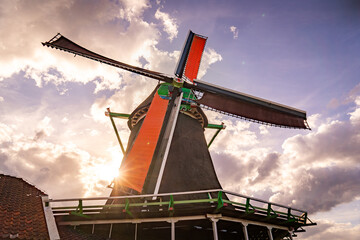 dutch windmill in the country during sunset - obrazy, fototapety, plakaty