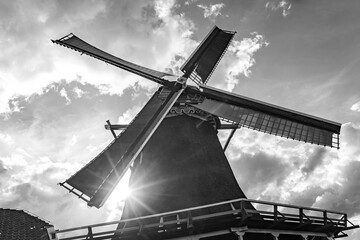 traditional windmill against sunny background in black and white
