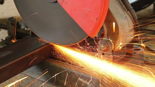 Worker are using grinder machine cutting a steel