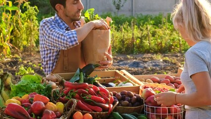Man and woman at a farmers market. Selective focus.