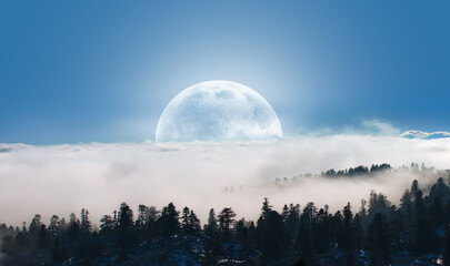 Fototapeta na wymiar Beautiful landscape with blue misty silhouettes of mountains against super blue moon 
