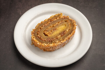 Traditional Portuguese cake roll Walnut pie and egg jam. With marble texture background. Torta de noz.