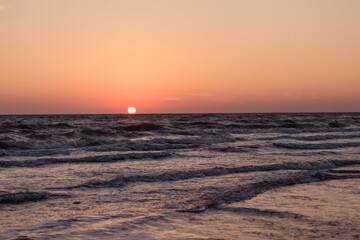 Sunrise over a choppy sea. Meditation on the background of the sea and sky. 