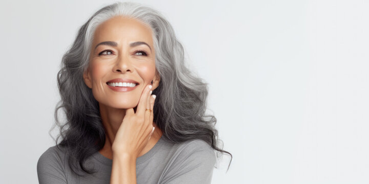 Portrait of a beautiful ageing mature black woman with long grey hair. Healthy face and skin care beauty, cosmetics, cosmetology concept.
