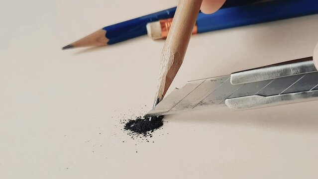 Use utility knife to sharpening pencil lead, close-up.