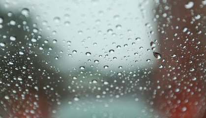 Raindrops on windowpane during a rainy day, capturing the tranquility and melancholy of nature's tears, evoking reflection and emotional depth