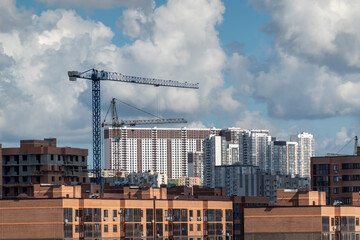 Fototapeta na wymiar Novorossiysk Two hoisting cranes and buildings under construction