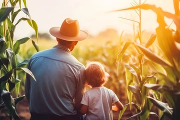 Schilderijen op glas A farmer with a child harvests corn in the field. Photo of little boy exploring cornfields on a lovely autumn day surrounded by the beautiful scenery © VisualProduction